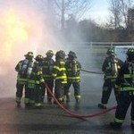 Team of fire fighters going through training